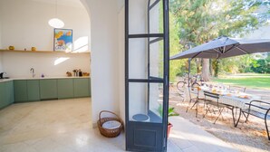 A modern kitchen with green cabinets, a hanging light fixture, and a framed picture on the wall. - Vallone Apartment S, Galatina, Italy (Galatina)