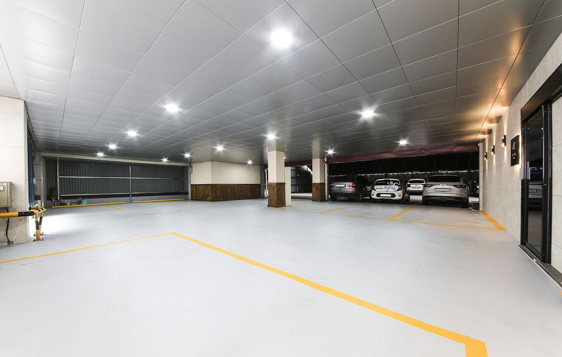 Un parking moderne à plusieurs niveaux, doté d’emplacements de stationnement clairement délimités et offrant un environnement propre et bien éclairé.