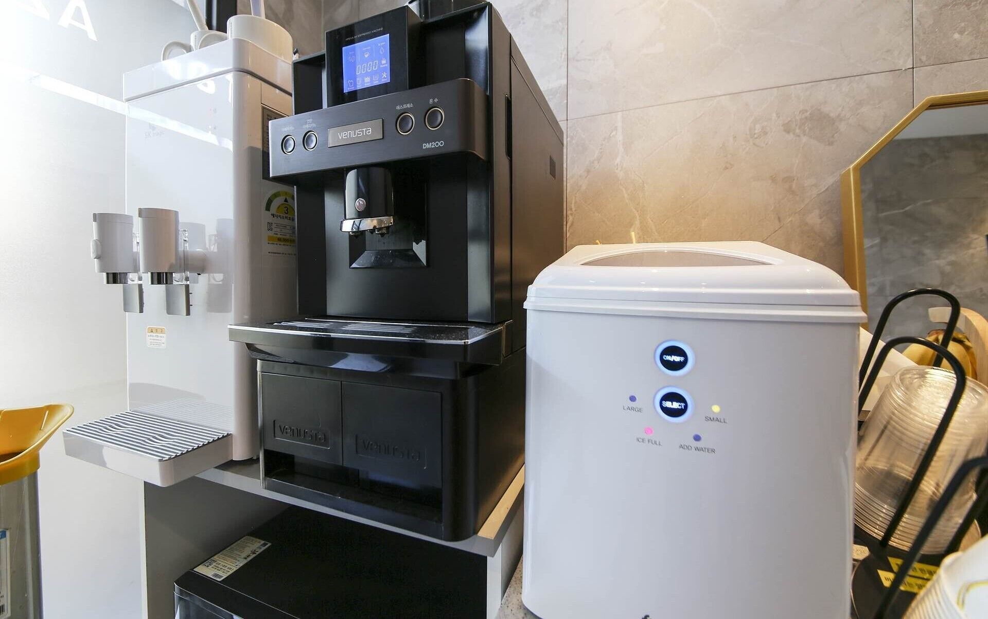 A water dispenser with a digital display, a water cooler, and a water bottle.