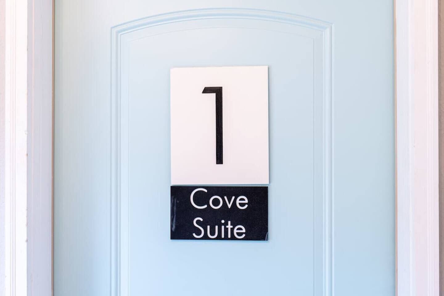 A door with a sign indicating "1 Cove Suite".