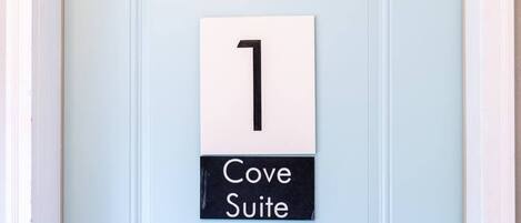 A door with a sign indicating "1 Cove Suite".