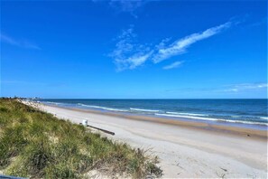 Enjoy a tranquil beach experience with gentle waves lapping onto the shore.