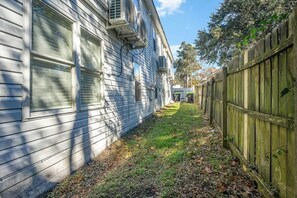Houses with attached garages line a shaded pathway.