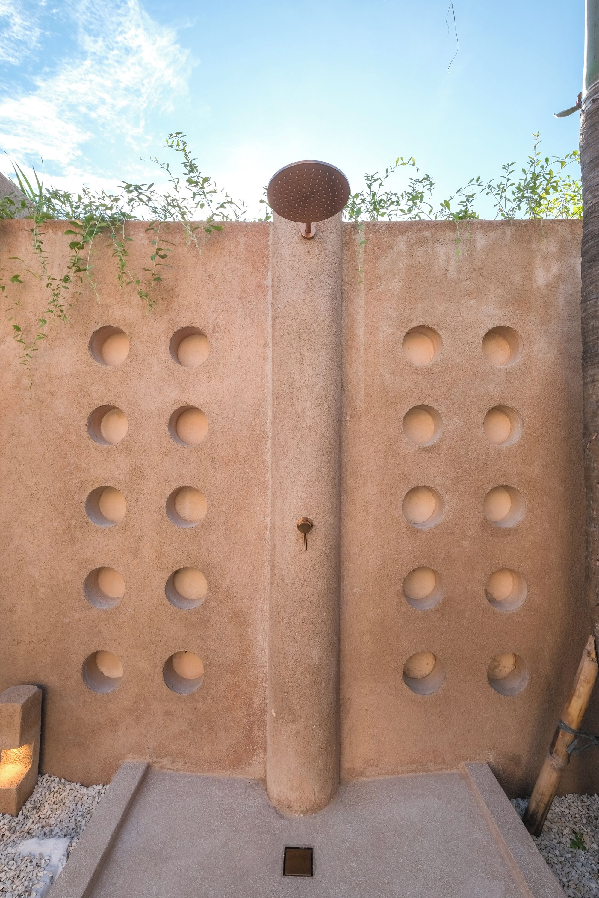 A wall with circular cutouts and a central column.