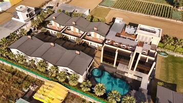 Relax on the spacious balconies or by the large swimming pool surrounded by lush landscaping and palm trees.