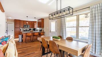 A modern kitchen with wooden cabinets, a stainless steel refrigerator, and a built-in microwave.