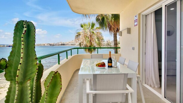A balcony with a table set for two, overlooking a coastal view. - Casa Marinita, Penthouse By The Sea (Arona)