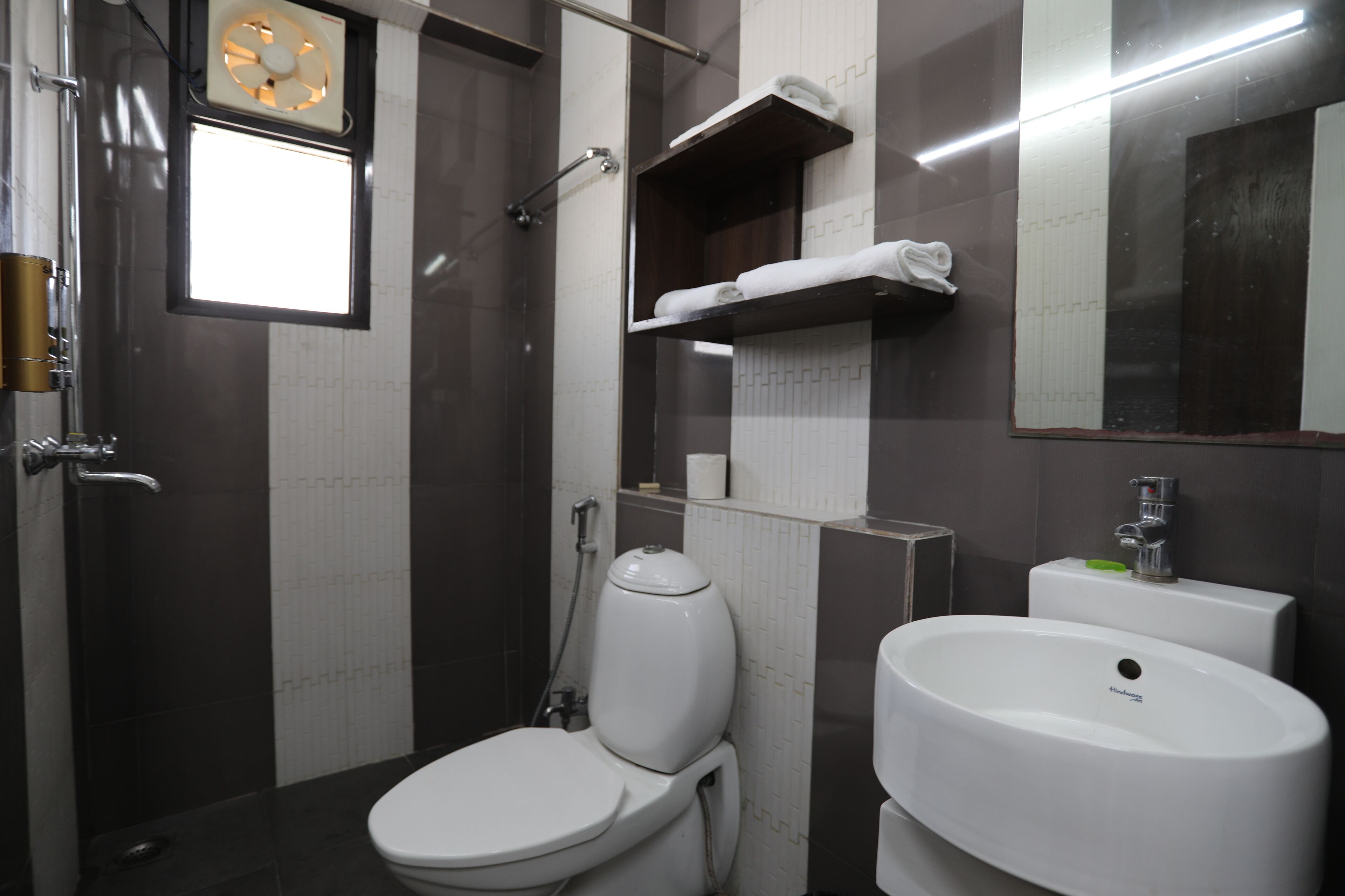 A modern bathroom with a toilet, sink, and shower.