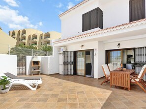 Enjoy al fresco dining on the patio with a grill and comfortable seating.