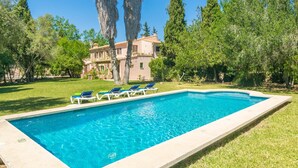 A rectangular swimming pool with a clear blue water, surrounded by a well-maintained lawn and trees. - Can Ferrer - Villa With Private Pool In Pollença (PollenÇa, Illes Balears)