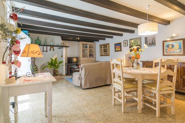 A cozy dining area with a table, chairs, and a lamp.