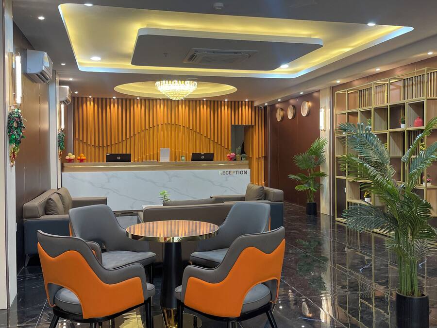 A modern reception area with a reception desk, seating area with chairs, and a reception sign.