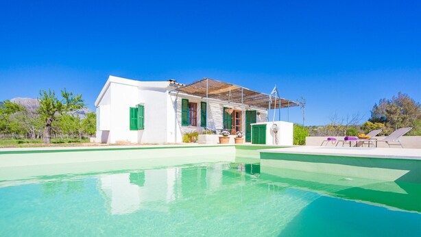 A house with a swimming pool, green shutters, and outdoor seating. - Ses Planes (ca Na Faustina) - Villa With Pool (Selva, Illes Balears)