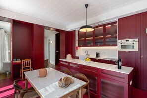Enjoy meals in this kitchen with an oven, dining table, and comfortable seating.