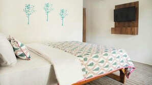 A bedroom with a bed, a wall-mounted TV, and three wall art pieces. - La Perla Resort By Circle Hotels&Resort (Morjim)