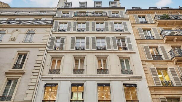 A multi-story building with a classic European architectural style, featuring symmetrical windows and decorative iron railings. - Sublime Apartment Rue Royale/madeleine (Paris)