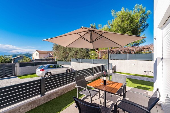 Relax under the shade of a large umbrella, surrounded by a serene natural view.