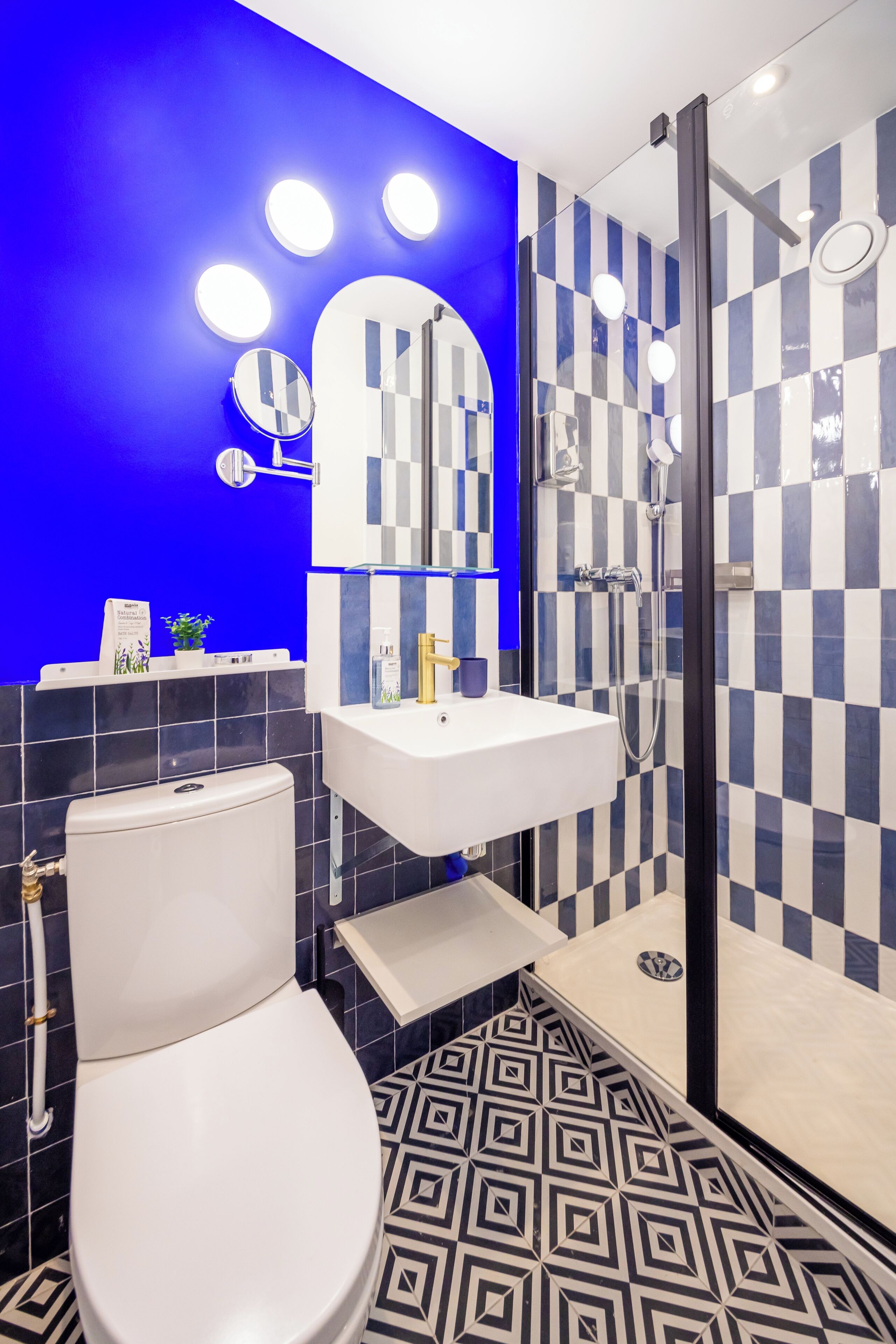 A modern bathroom with a white toilet, a sink, and a shower.