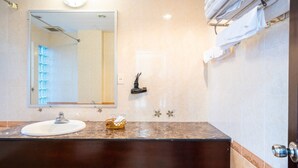 A bathroom with a marble countertop, a sink, a mirror, and a towel rack. - Shine Hue Hotel 2  (Hue)