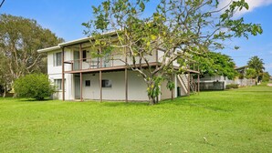 A two-story house with a covered porch and a small tree in front. - Welcome to Waterfront Views (Gympie)