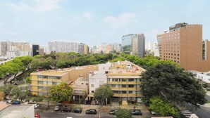 A multi-story hotel with a modern design, surrounded by other buildings and greenery. - w* | Great 2BR Apartment with Balcony in Miraflores (Lima)