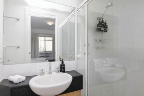 Shower, hair dryer, towels, shampoo