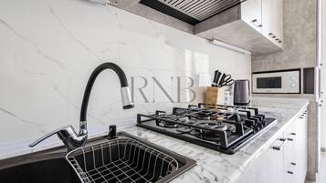 Family Condo, Balcony, City View | Private kitchen | Electric kettle
