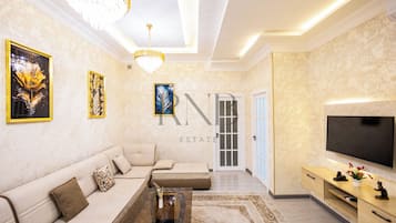 Family Condo, Balcony, City View | Living area | Flat-screen TV