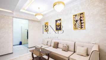 Family Condo, Balcony, City View | Living area | Flat-screen TV