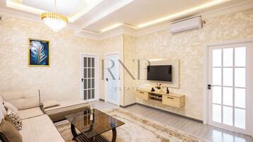 Family Condo, Balcony, City View | Living area | Flat-screen TV