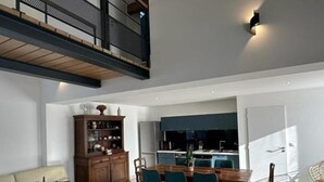 A modern living room with a dining area, a kitchen, and a balcony. - Cozy house with pool and garden in Brantôme (Brantôme en Périgord-Brantôme en Périgord)
