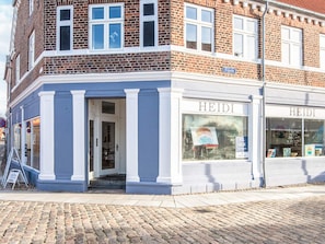 A corner building with a shop named 'HEIDI' on the ground floor.