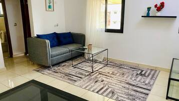 Deluxe Suite, Balcony, City View | Living area | 43-inch Smart TV with cable channels