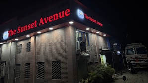 A building with a sign reading "The Sunset Avenue" at night. - Hotel The Sunset Avenue (Mumbai)