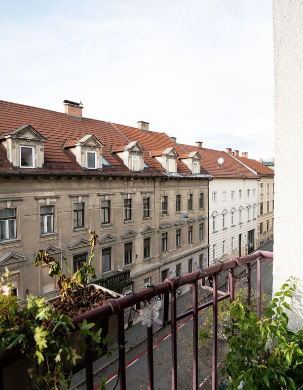 A row of historic buildings with red-tiled roofs and multiple windows.