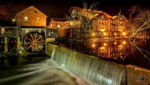 A historic building with a large water wheel and a restaurant. - Eagles Ridge Cabin · Hot Tub, Jacuzzi & Pool Table (Pigeon Forge)