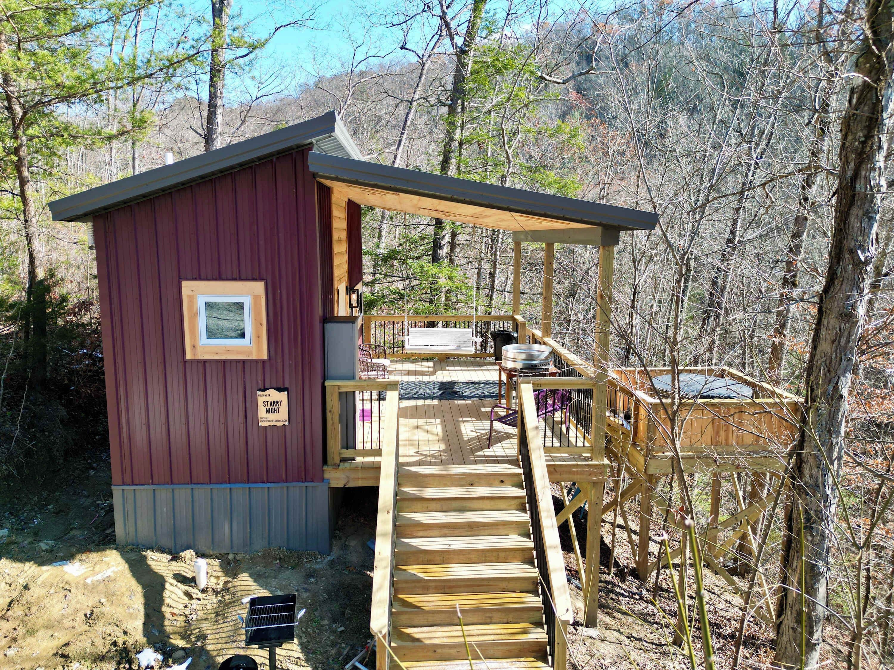 A cabin with a wooden deck, a small porch, and a sign that reads 'STARRY NIGHT.'