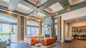 A spacious living area with a fireplace, comfortable seating, and a view of the outdoors.