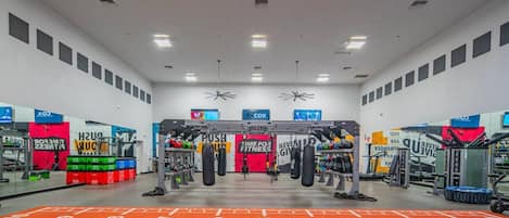 A gym with various exercise equipment, including a pull-up bar and punching bags.