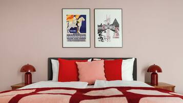 A hotel room with a bed, two bedside tables, and two framed pictures on the wall.