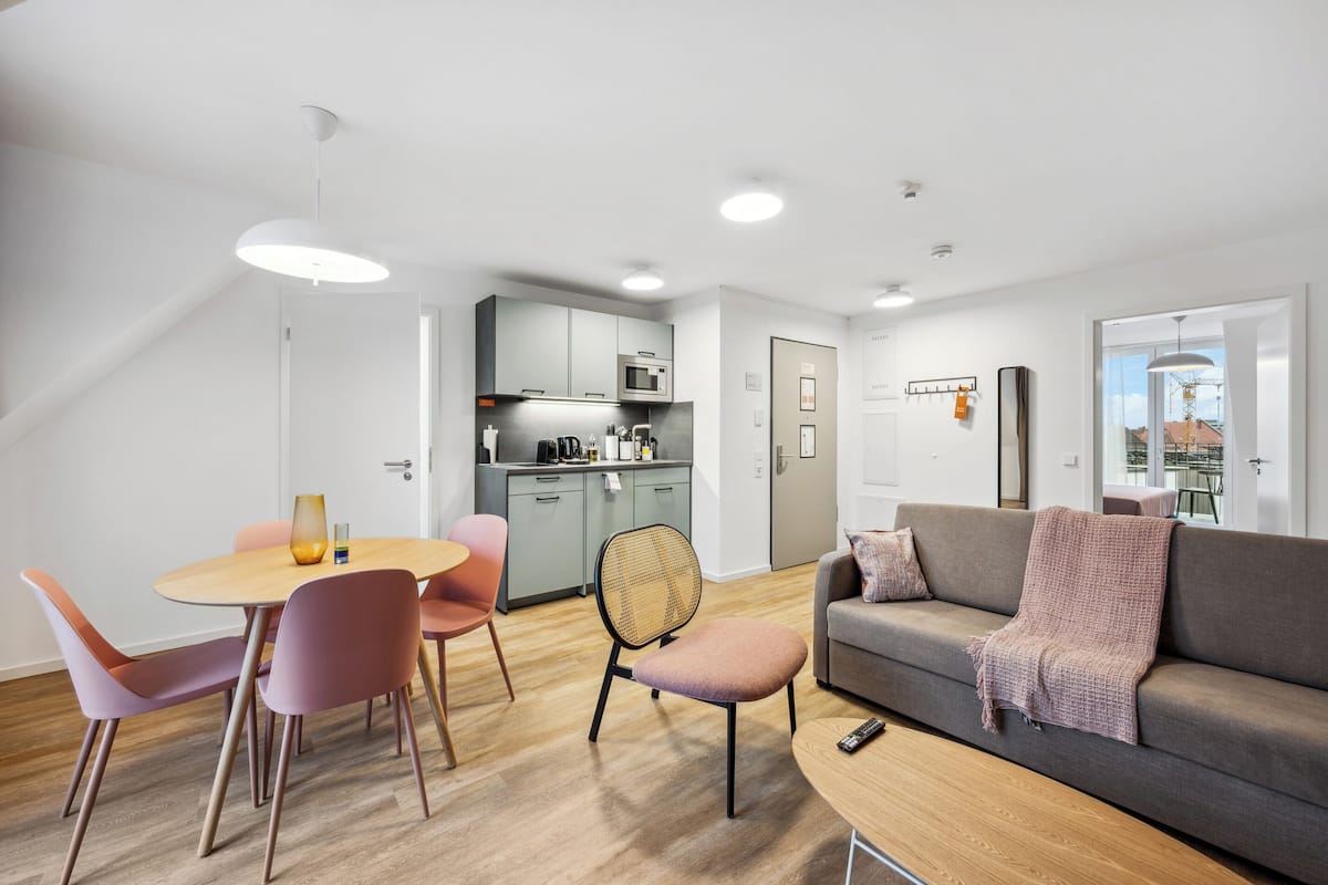 One-bedroom Comfort Suite with Balcony | Living area | 50-inch flat-screen TV with cable channels