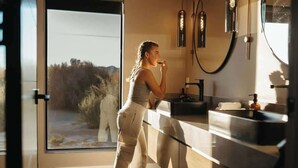 A modern bathroom with a large window, a sink, and a mirror. - Free Bird • Pool, Spa, Pickleball, Outdoor Lvg Rm! (Joshua Tree)