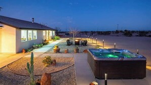 A modern house with a hot tub, outdoor seating, and a well-maintained garden. - Winters Haven · 2.5 Acres, Spa, PingPong, SoakPool (Joshua Tree)
