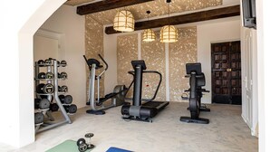 A home gym with exercise equipment, a weight rack, and exercise mats. - Splendid Flat in Provencal Villa 1br/3p (Grimaud)