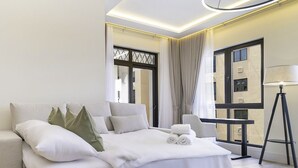 A modern bedroom with a bed, bedside table, and a lamp.