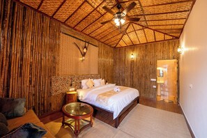 A room with a bed, a round wooden table, and a ceiling fan. - Bento The Nature Walk, Mukteshwar (Dhari)