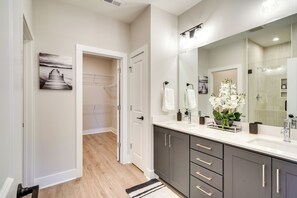 A modern bathroom with a large mirror, a sink, and a shower area. - 2 Mi to Duke & 3 Mi to Downtown: Durham Townhome (Durham)