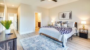 A bedroom with a bed, bedside tables, a ceiling fan, a painting, and a potted plant. - 2 Mi to Duke & 3 Mi to Downtown: Durham Townhome (Durham)
