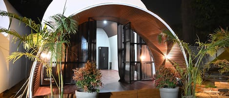 A modern, dome-shaped building with a wooden exterior and large windows.