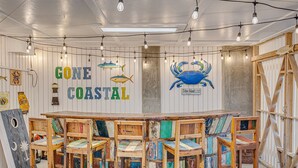 A coastal-themed bar area with wooden furniture and maritime decorations. - Oceanfront Home w/ Private Beach Access + Soaring Views by Tybee Cottages (Tybee Island)